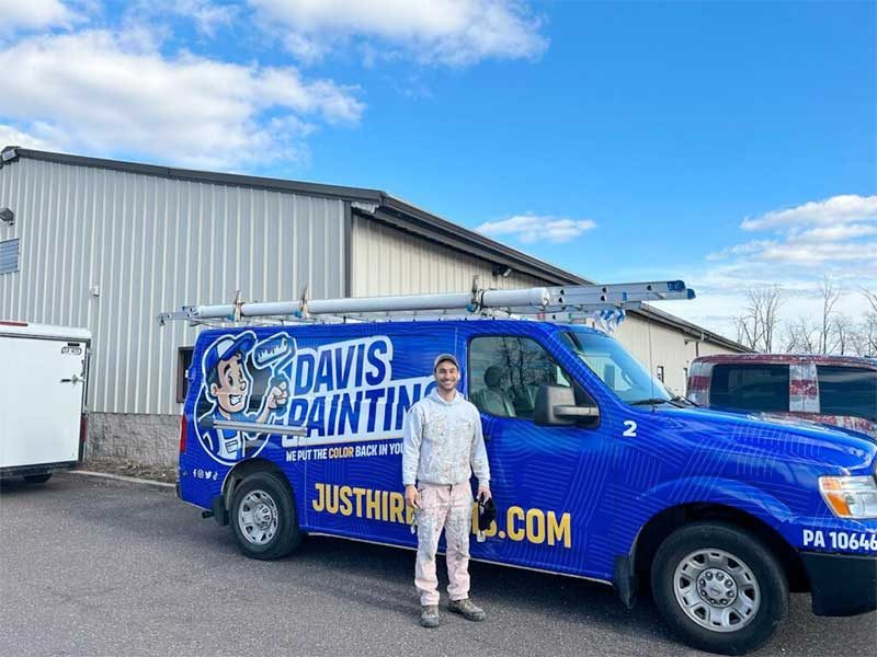 Davis Painting's Nate in front of our wrapped fleet!